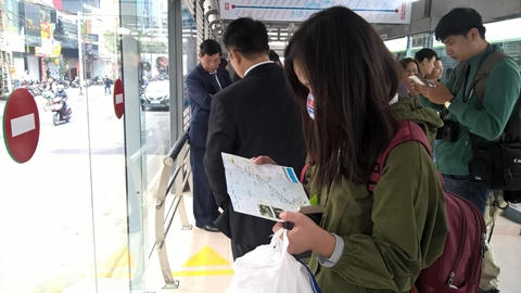 Một hành khác tranh thủ tìm hiểu lộ trình xe buýt nhanh.