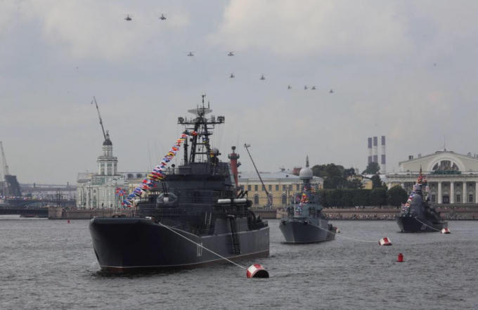 Máy bay trực thăng quân sự Nga bay theo đội hình các tàu hải quân của Hạm đội Baltic trên sông Neva trong một buổi diễn tập cho cuộc diễu hành quân sự Ngày Hải quân ở St. Petersburg, Nga ngày 28/7/2017.  Ảnh: Reuters
