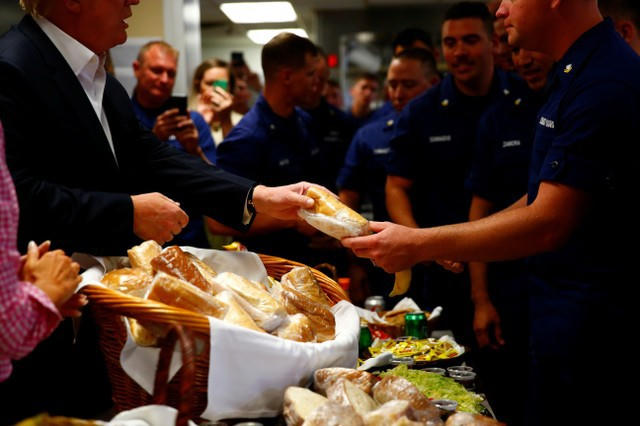 Tổng thống Trump và phu nhân đã tự tay phát đồ ăn trong bữa ăn trưa cho các nam và nữ quân nhân làm việc tại căn cứ của Lực lượng Tuần duyên - nơi nằm gần khu nghỉ dưỡng sân golf Mar-a-Lago của nhà lãnh đạo Mỹ. (Ảnh: Reuters)