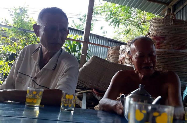 Ông Mỹ (bên phải) cha ruột của anh Mười kể về chuyện con trai trúng số độc đắc.