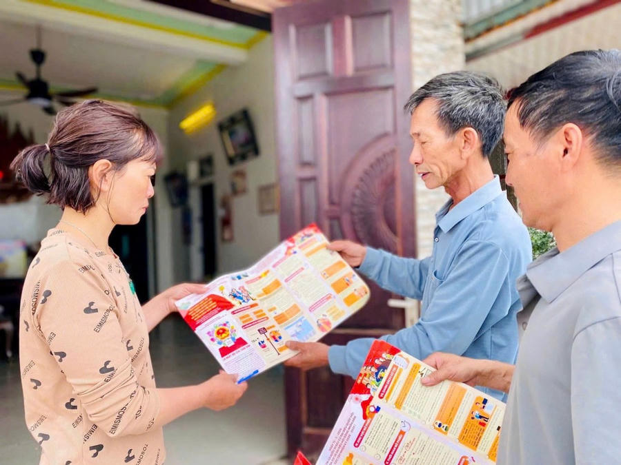 Cán bộ khu phố phát tờ rơi tuyên truyền, hướng dẫn người dân tìm hiểu thông tin về bầu cử đại biểu Quốc hội và HĐND các cấp.