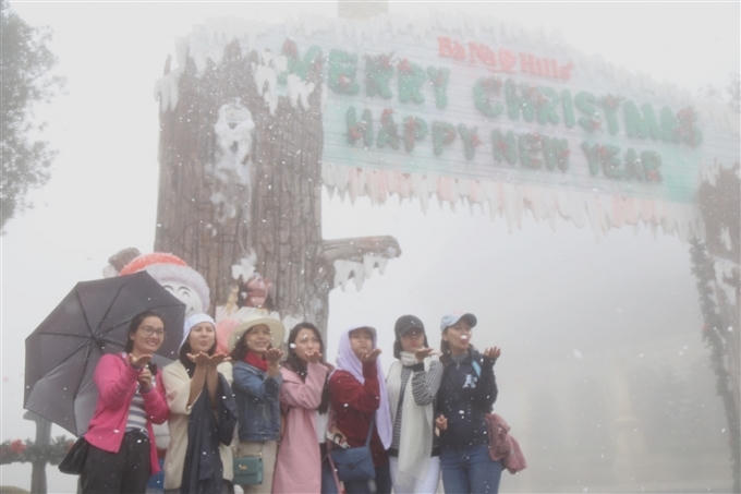 Nhiều bạn trẻ thích thú lưu lại những hình ảnh đẹp ngay cổng chào với những bông tuyết bay trắng trời…