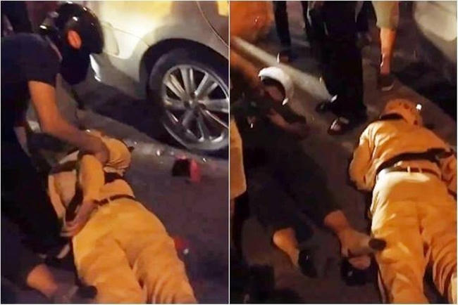 Hình ảnh hai cảnh sát bất tỉnh sau khi ngã ra đường. (Ảnh cắt từ clip)