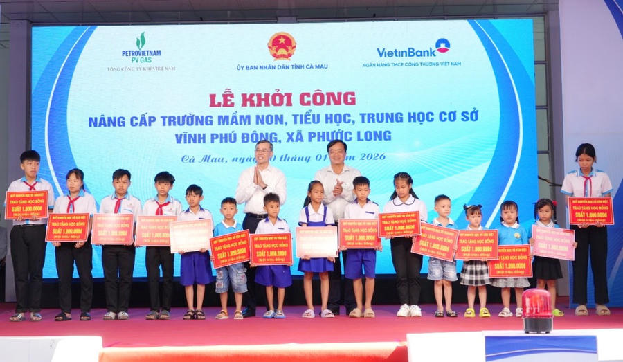 Ông Ngô Văn Tuấn (bên trái) – Ủy viên BCH TW Đảng, Tổng Kiểm toán Nhà nước và ông Huỳnh Quốc Việt – Ủy viên dự khuyết BCH TW Đảng, Phó Bí thư Thường trực Tỉnh ủy Cà Mau, trao học bổng cho các em học sinh.