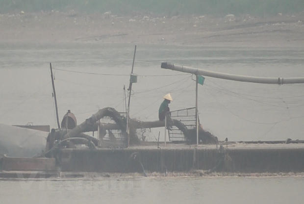 Hoạt động khai thác cát trá hình "núp bóng" dự án nạo vét. (Ảnh: PV/Vietnam+).
