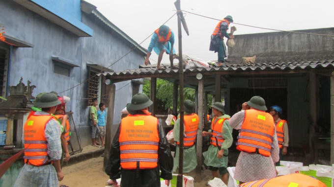 Bộ độ Biên phòng giúp dân chằng chống nhà cửa khi mùa mưa bão đến.