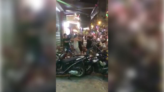 Hình ảnh nhóm thanh niên hùng hổ cầm gậy lao vào đánh nhau.