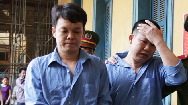 Phụng (trái) và Sơn bị áp giải sau phiên tòa phúc thẩm. (Ảnh: Zing.vn)