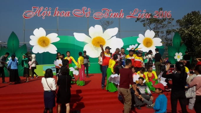 Du khách chụp ảnh lưu niệm sau khi khai Hội hoa Sở.