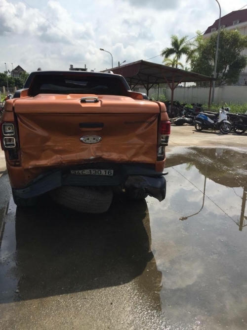 Xe bán tải màu vàng cam bị hỏng phần đuôi sau khi đâm đối thủ.