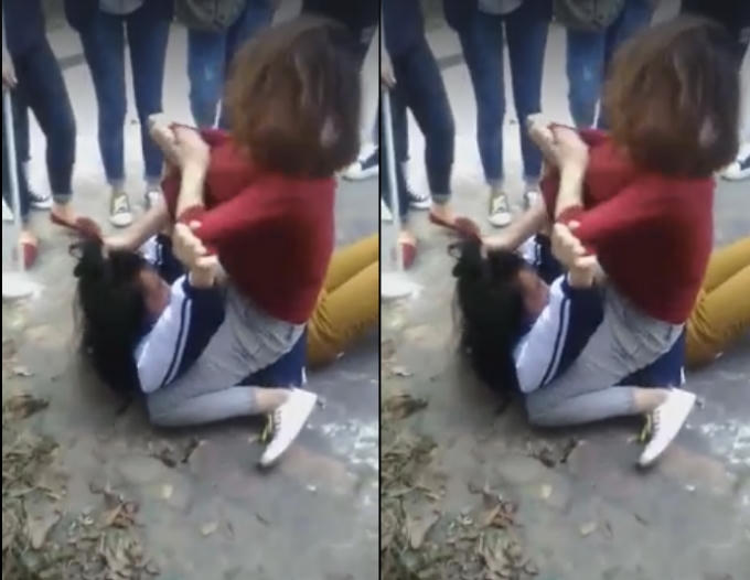 2 nữ sinh đánh nhau dã man trước sự hò reo cổ vũ của đông đảo người chứng kiến.
