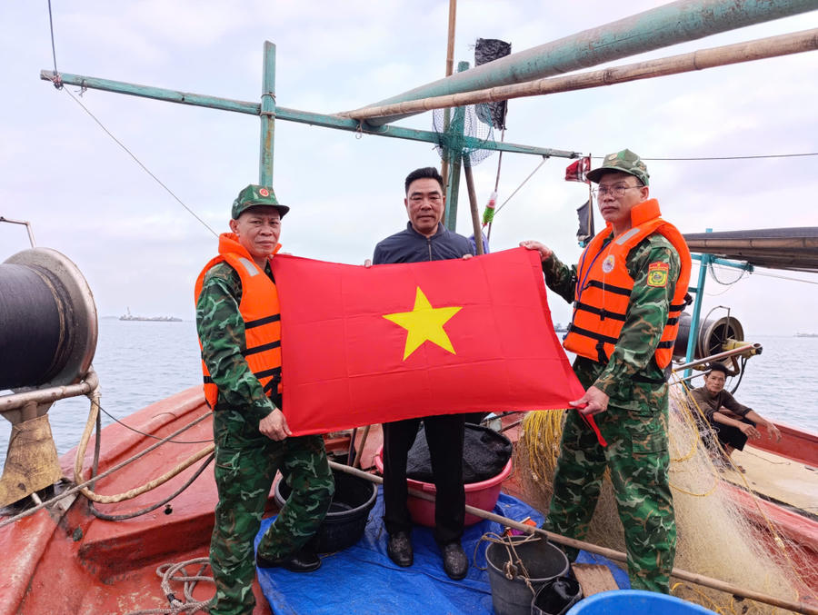 Đồn Biên phòng Cửa khẩu cảng Vạn Gia tặng cờ Tổ quốc cho ngư dân.