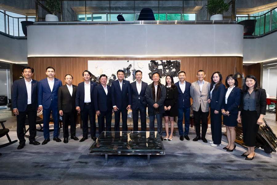 A group of people standing in front of a coffee table

Description automatically generated