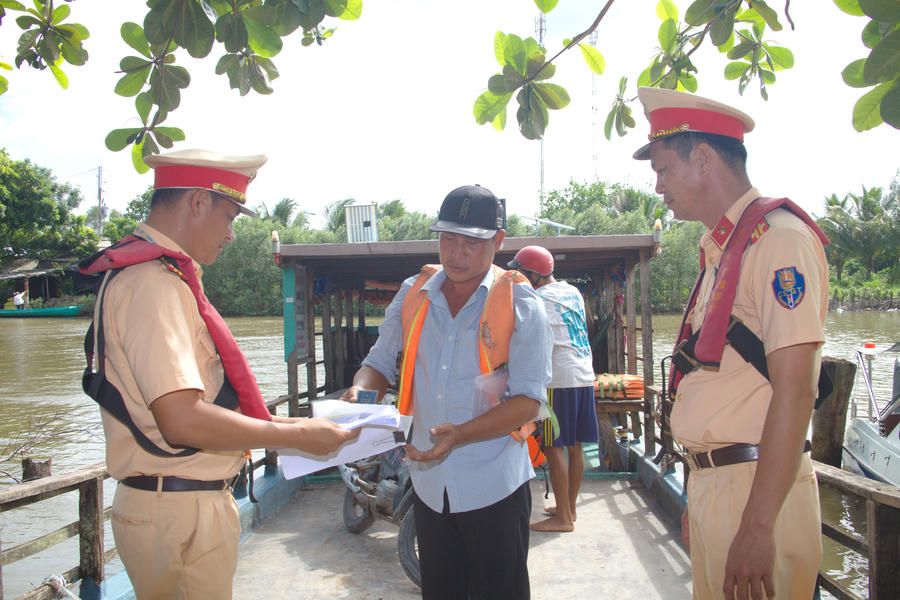 Cán bộ Trạm Cảnh sát đường thủy Hòa Trung kiểm tra điều kiện an toàn phương tiện, đăng ký, đăng kiểm và việc trang bị áo phao tại bến phà Ông Muộn trên tuyến đường thủy nội địa.