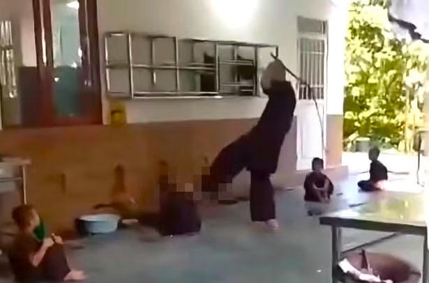 Hình ảnh người đàn ông đánh cháu bé.